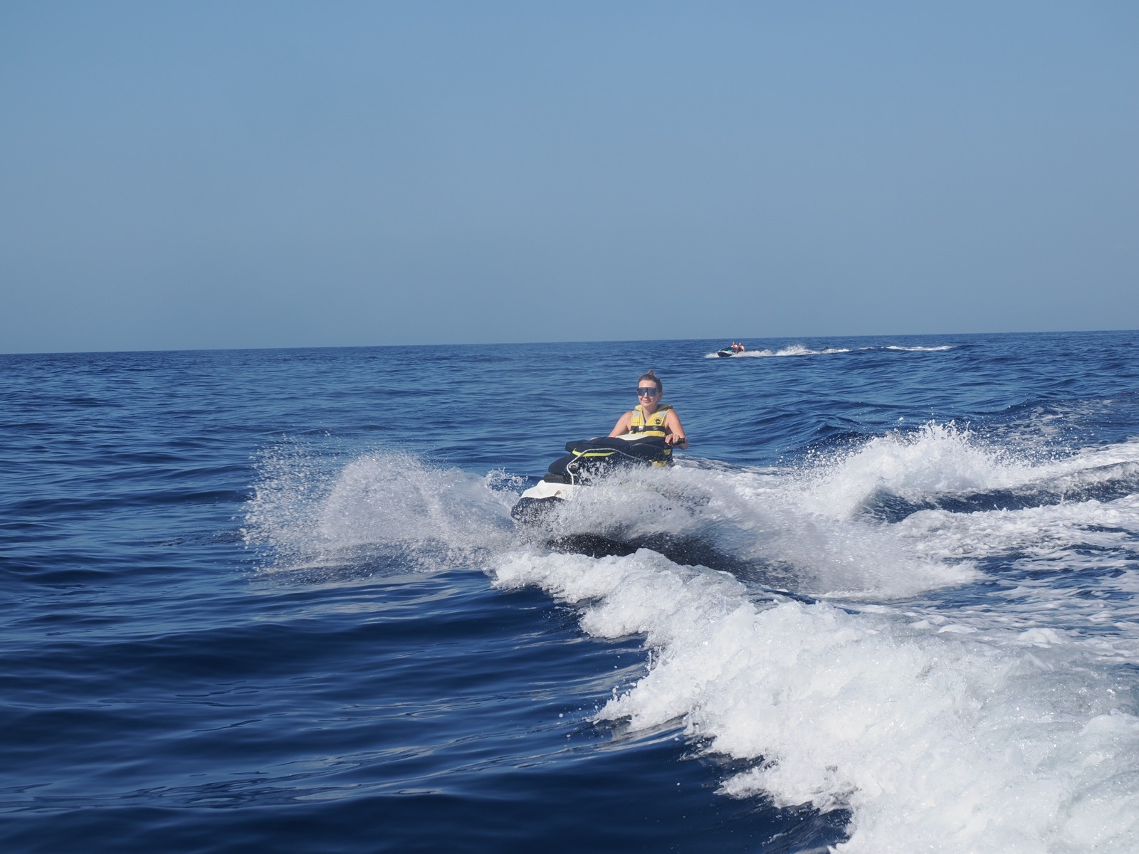 Jet ski crossing a boat wake off Costa Adeje